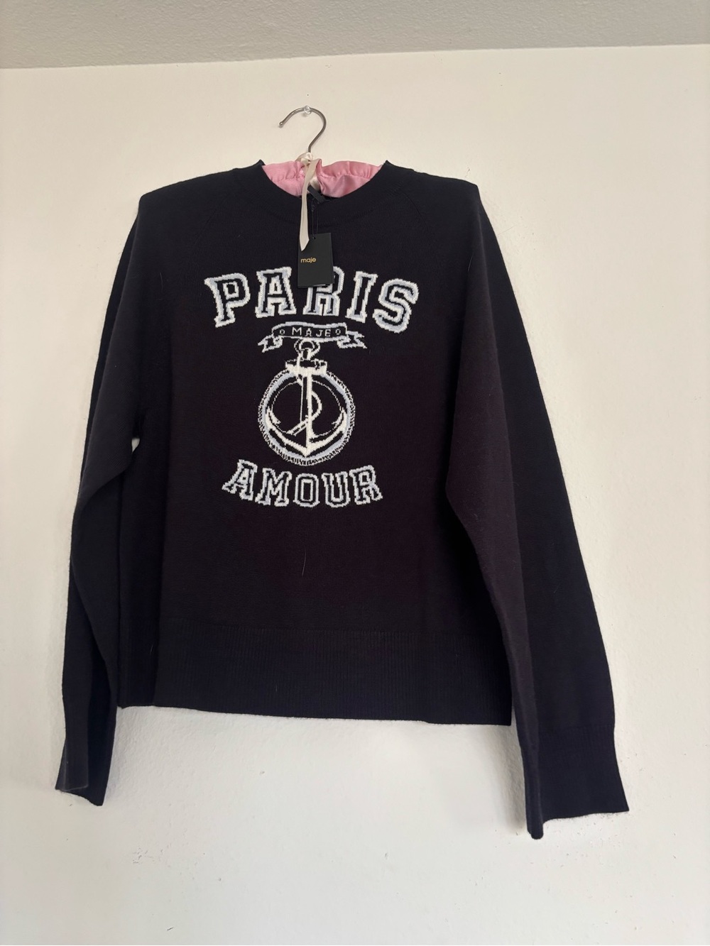 Maje Paris Amour black sweater with white graphic featuring 'PARIS' and 'AMOUR'